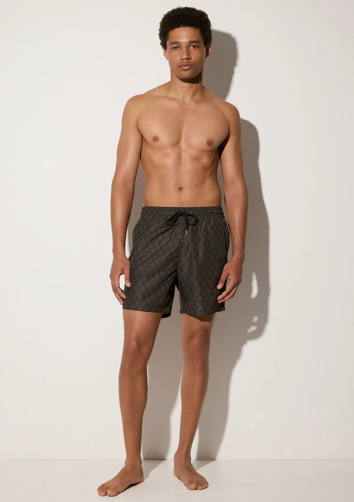 lumari-polyester-swim-shorts-coco-mocha-lifestyle-front Lumari Swim Shorts - Black - Sea You Soon
