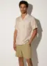 pekan-tencel-shirt-sand-lifestyle-side Pekan TENCEL™ short sleeve shirt in Sand, front view on white background by Sea You Soon